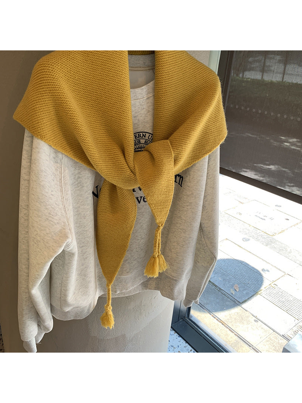 Close-up of the Mustard Yellow triangle scarf knot and tassels