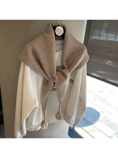 Khaki textured triangle scarf tied with tasselled ends