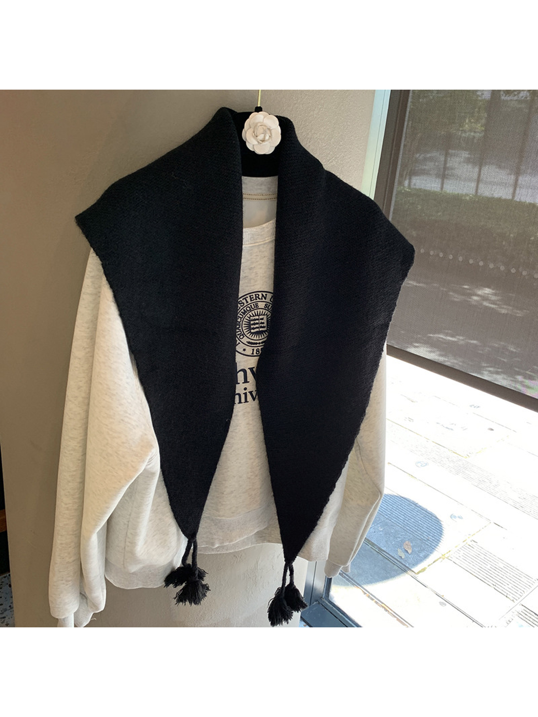 Black textured triangle scarf with tassels, front view
