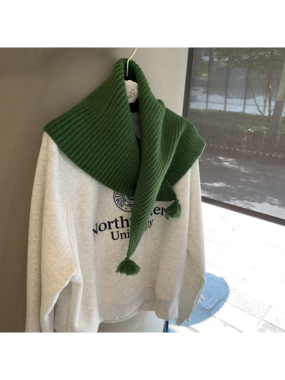 Dark Green ribbed triangle scarf styled asymmetrically with tassel ends