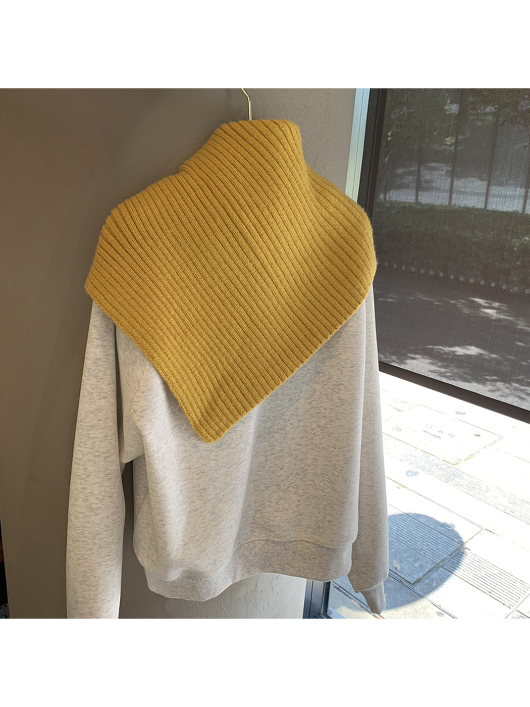 Back view of the Mustard Yellow ribbed triangle scarf showing its pointed shape