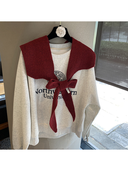 Burgundy ribbed tie-front shoulder scarf styled in a bow