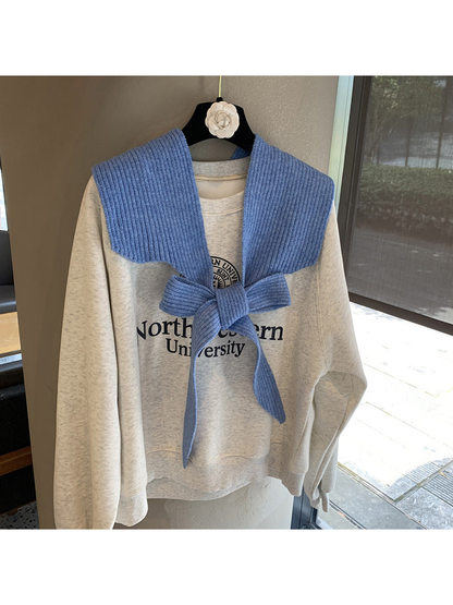 Blue ribbed tie-front shoulder scarf styled in a bow