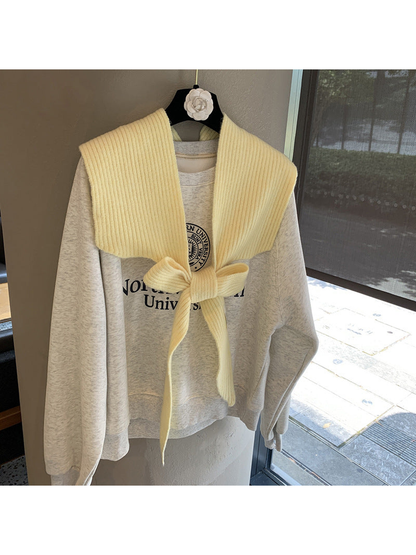 Yellow ribbed tie-front shoulder scarf styled in a bow