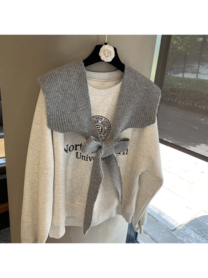 Gray ribbed tie-front shoulder scarf styled in a bow
