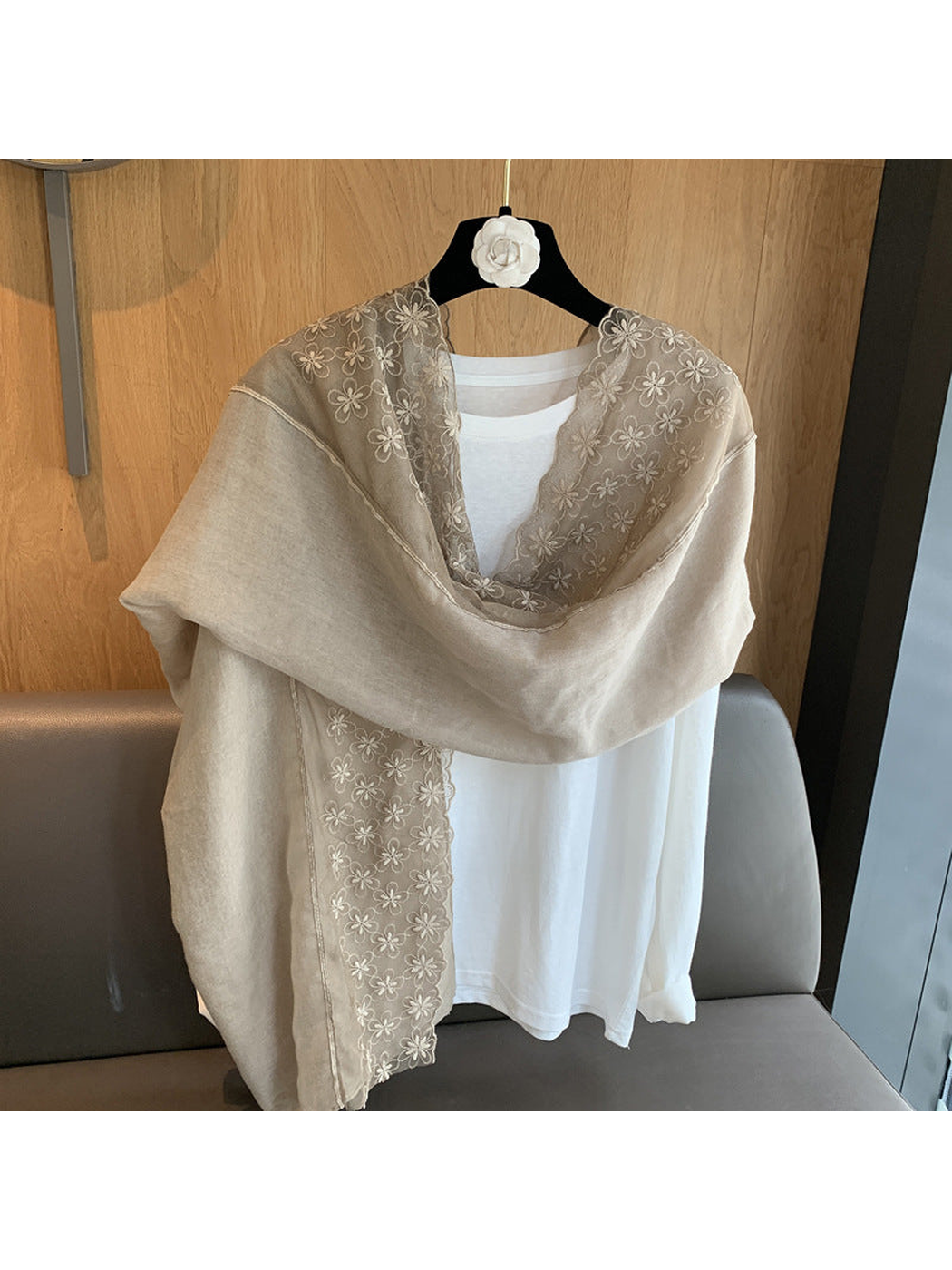 Greige floral-border scarf draped around the shoulders