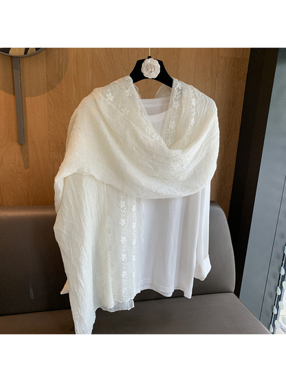 Ivory floral embroidered scarf draped over the shoulders