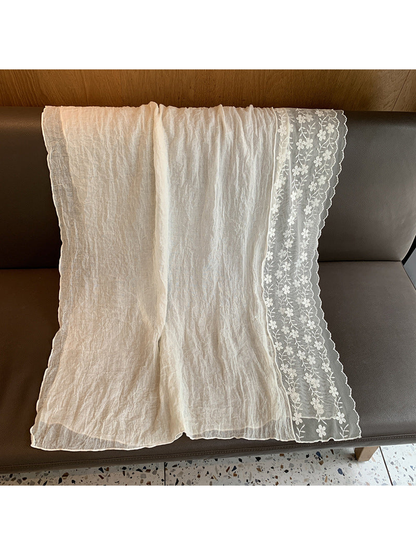 Ivory rectangular scarf laid flat with a floral vine border