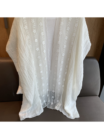Close-up of the Ivory scarf's crinkled texture and floral border
