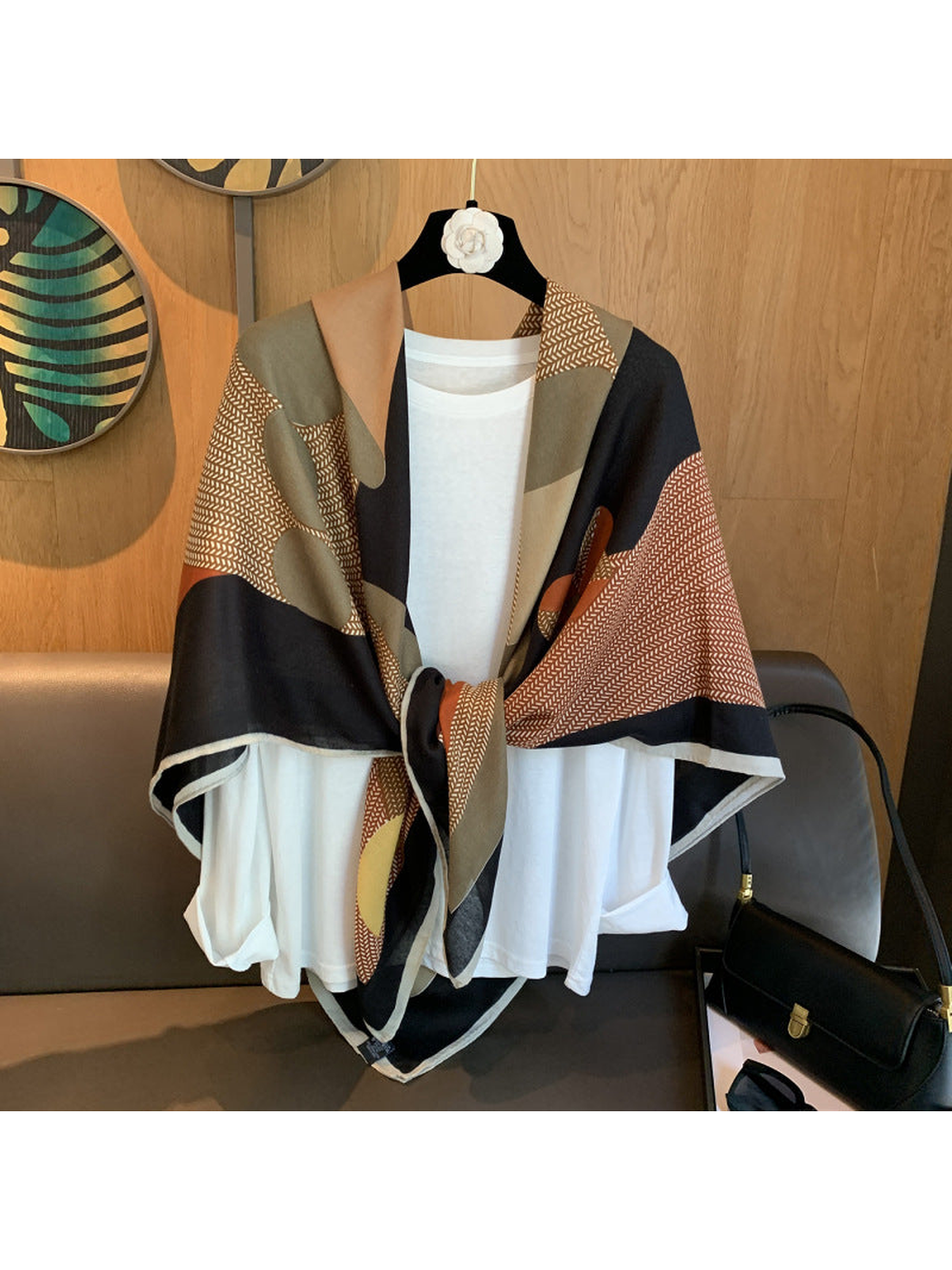 Multicolor abstract-pattern square scarf tied over a white top