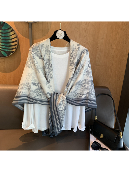 Ivory and gray-blue illustrated scarf styled in a front knot