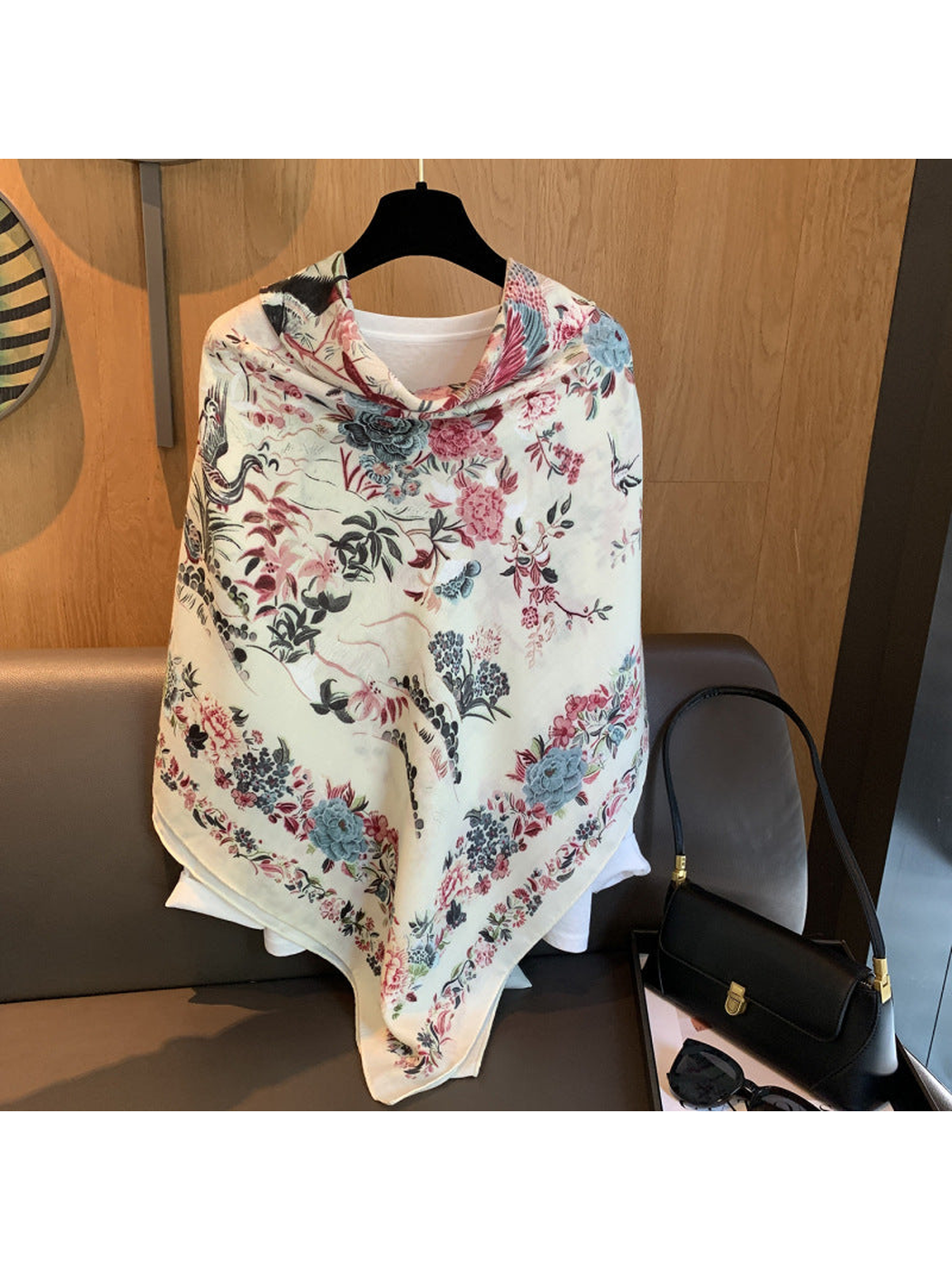 Ivory floral and bird square scarf draped over a white top