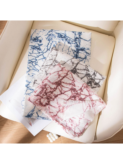 Burgundy, Black Gray and Blue abstract-print scarves arranged with fringed edges visible
