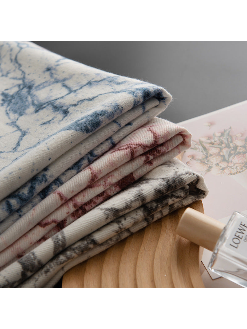 Blue, Burgundy and Black Gray abstract-print scarves folded in a stack