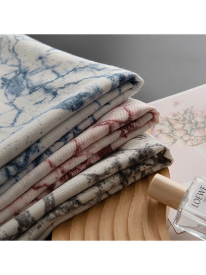 Blue, Burgundy and Black Gray abstract-print scarves folded in a stack