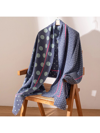 Long navy patterned scarf displayed over a wooden chair