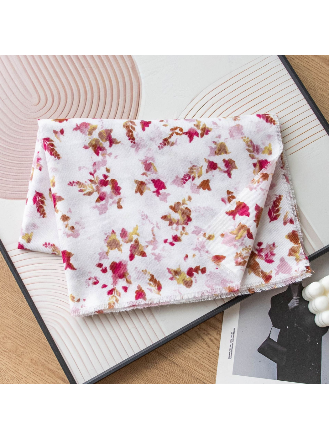 Ivory scarf with scattered pink and brown floral print, folded view