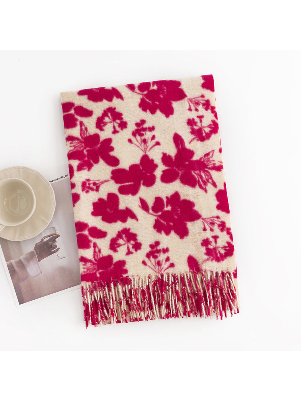 Pink and cream floral scarf folded to show the fringed end