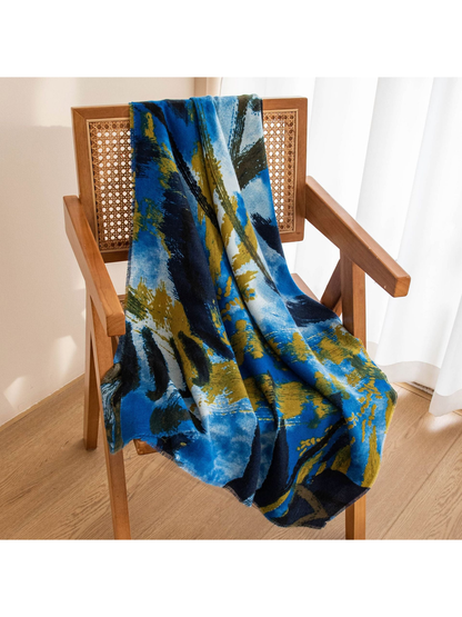 Blue abstract brushstroke scarf draped across a wooden chair