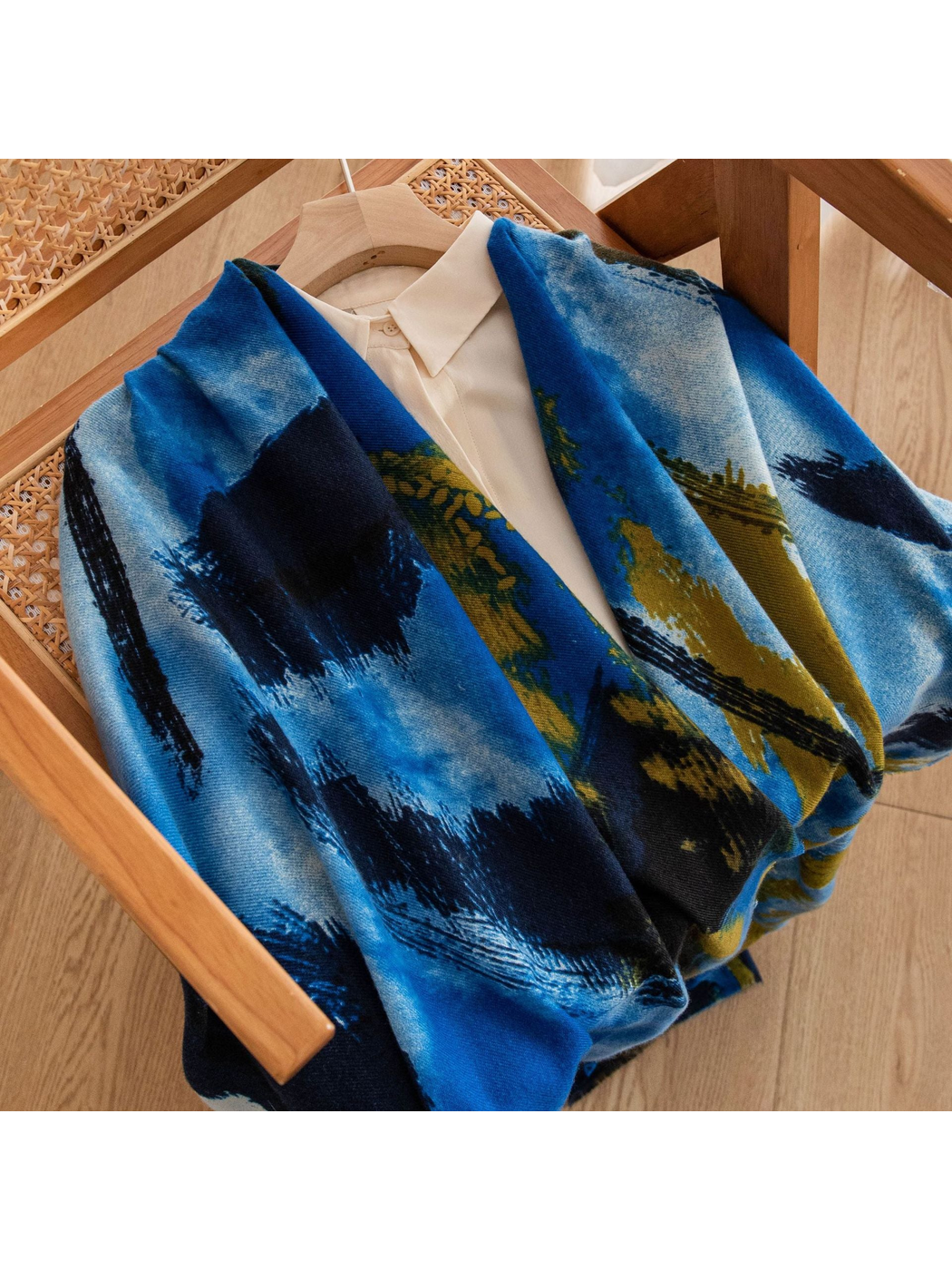 Blue abstract brushstroke scarf styled over a cream collared blouse