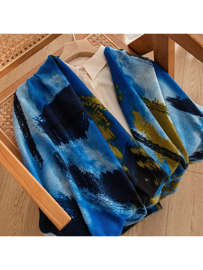 Blue abstract brushstroke scarf styled over a cream collared blouse