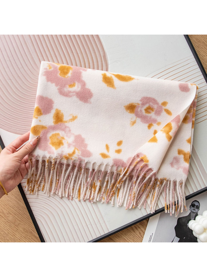 Close view of the floral scarf pattern and long fringe
