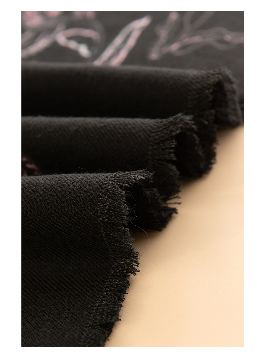 Close-up of the black scarf's short fringed edge