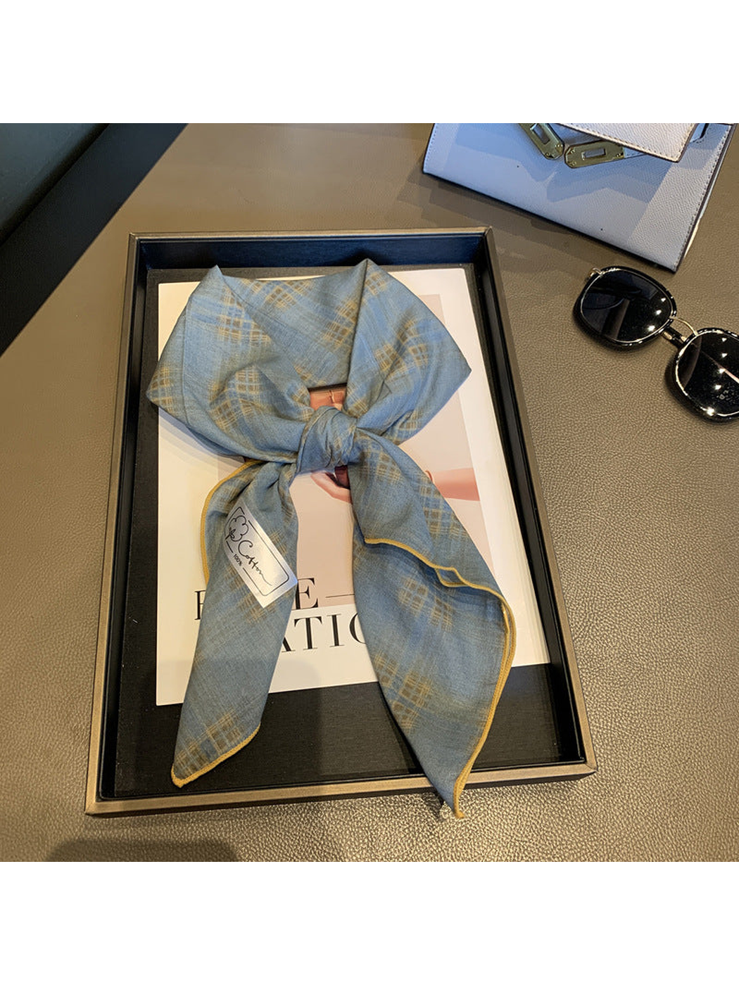 Blue Gray check scarf tied in a loose knot