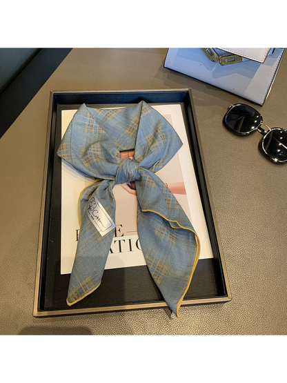 Blue Gray check scarf tied in a loose knot