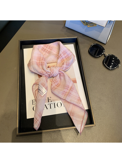 Light Pink plaid scarf tied in a loose knot