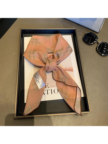 Dusty Pink check scarf tied in a loose knot