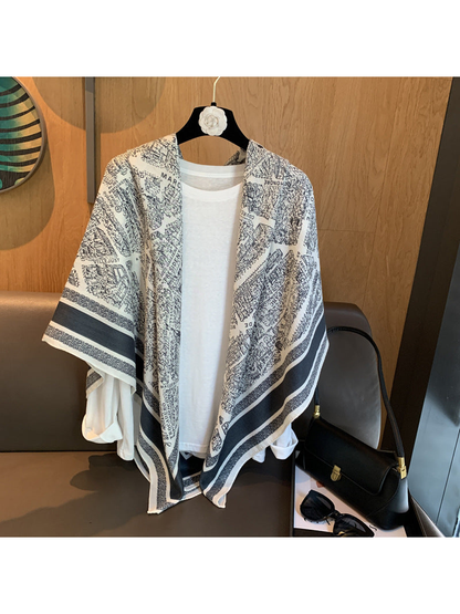 Ivory and navy city map print square scarf draped loosely over a white top