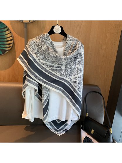 Ivory and navy city map print square scarf styled in an asymmetrical shoulder drape