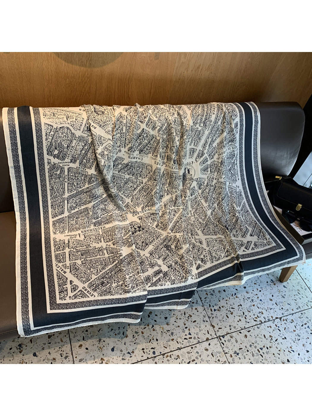 Ivory and navy square scarf spread open to show the city map print and striped border