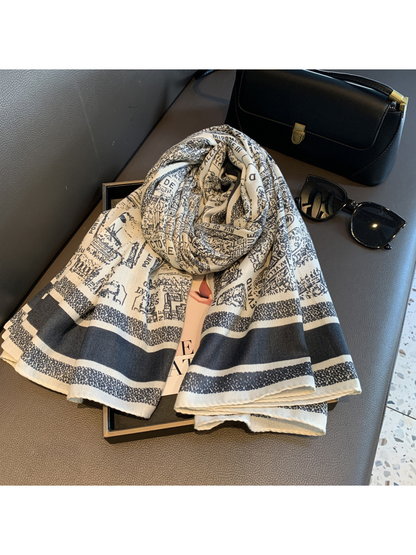 Ivory and navy city map print scarf loosely rolled with its striped ends displayed