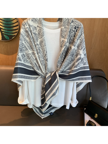 Close-up of the tied scarf front with city map print and navy striped border