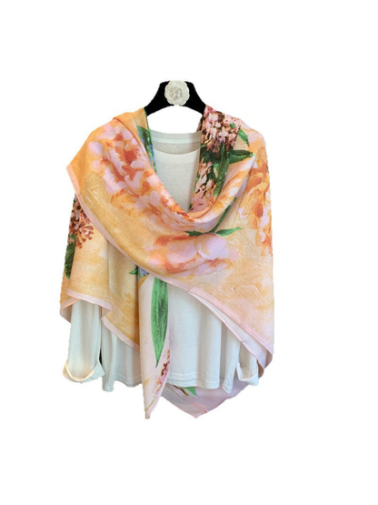 Multicolor floral square scarf draped over a white top