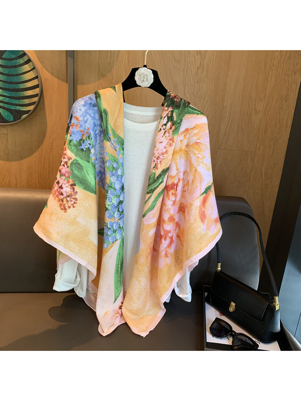 Multicolor floral scarf draped loosely over a white top