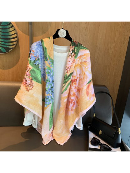 Multicolor floral scarf draped loosely over a white top