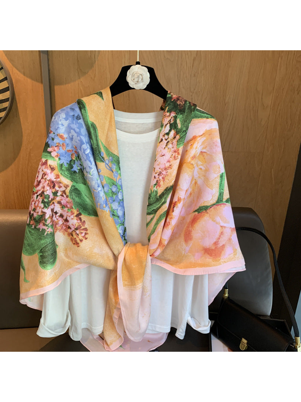 Multicolor floral scarf tied at the front over a white top
