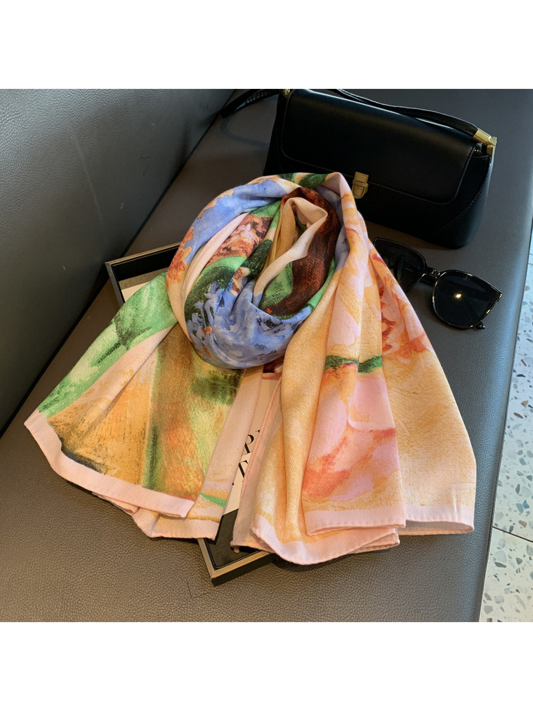 Folded floral scarf showing peach, blue and green print details