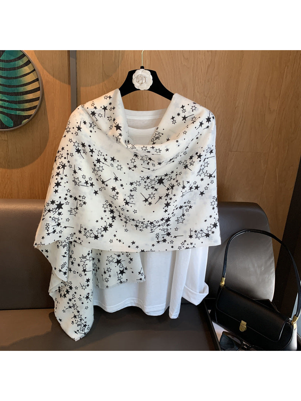 White star-print scarf styled in a wide shoulder drape