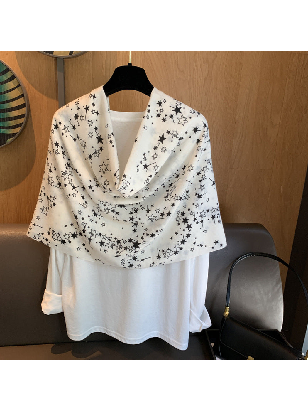 White star-print scarf styled in a softly looped drape
