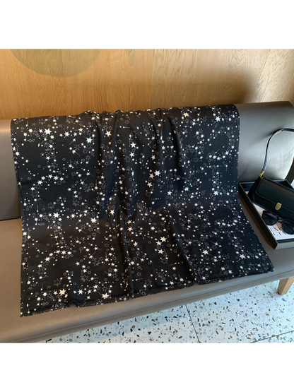 Black rectangular star-print scarf spread to show its full shape
