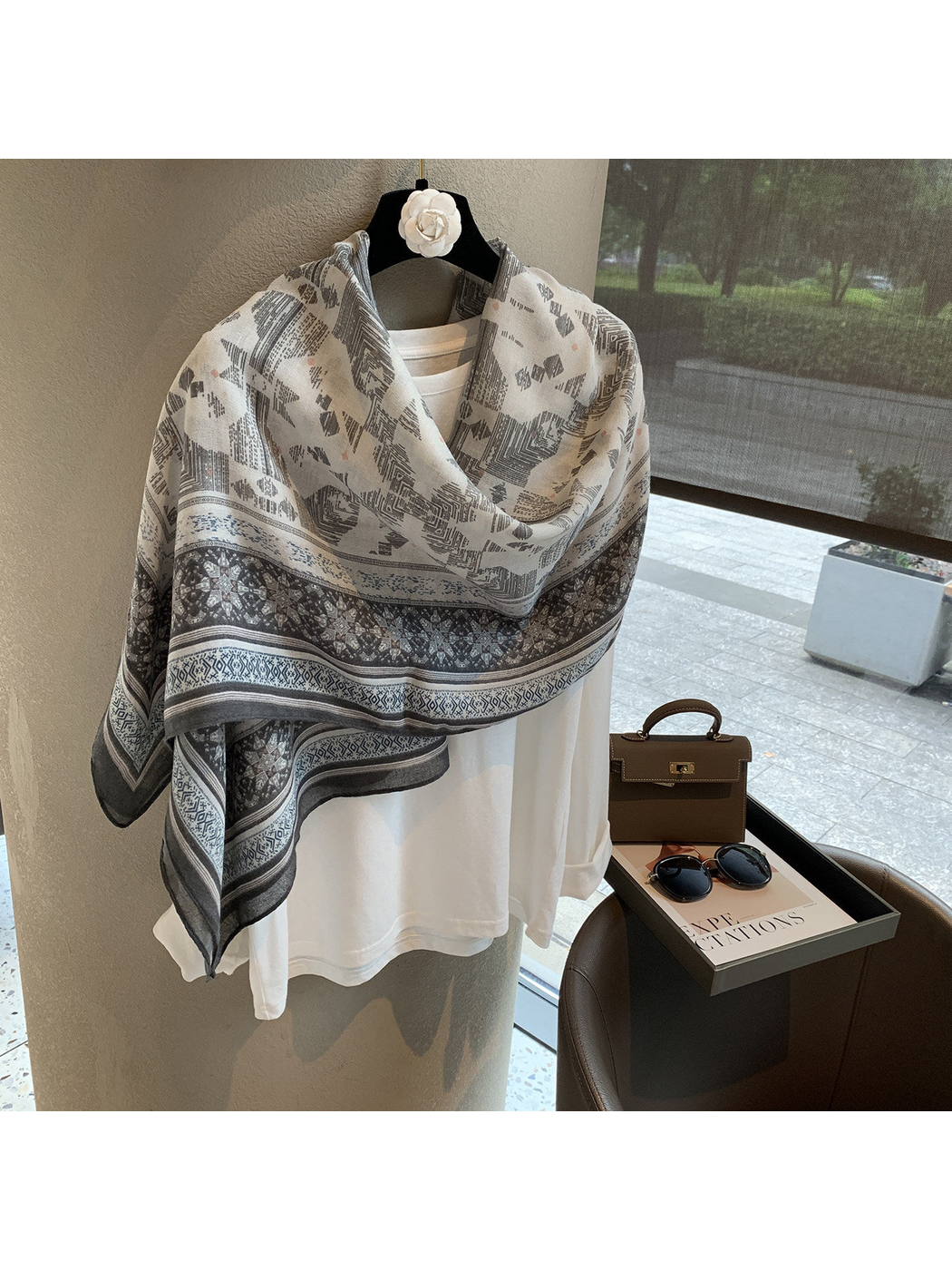 Gray and ivory geometric scarf wrapped across the shoulders