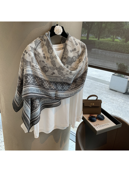 Gray and ivory geometric scarf wrapped across the shoulders