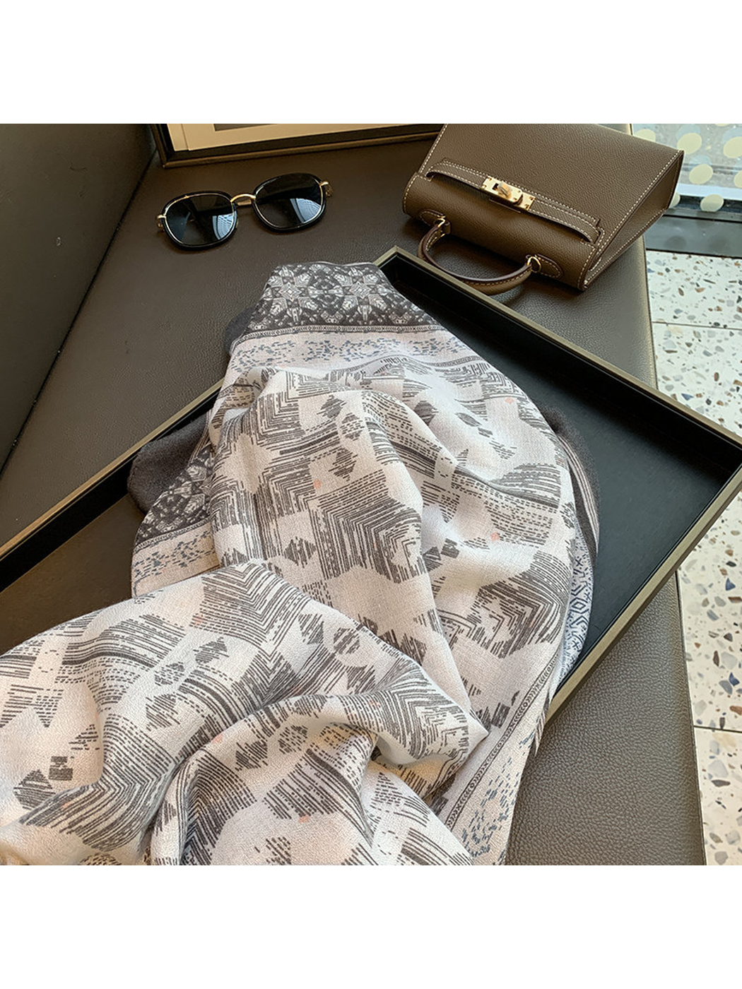 Close-up of the scarf's fine woven-look texture and abstract geometric print