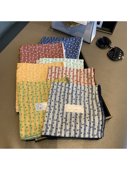 Bow and floral square scarves displayed in multiple styles