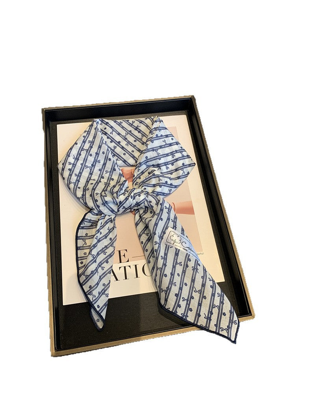 Blue White bow-and-flower square scarf tied in a loose knot