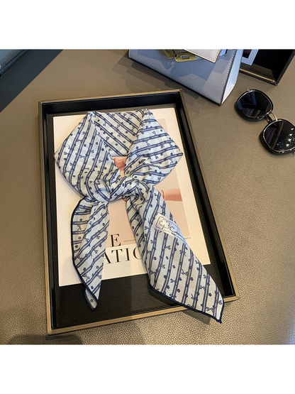 Blue White bow-and-flower square scarf tied in a loose knot
